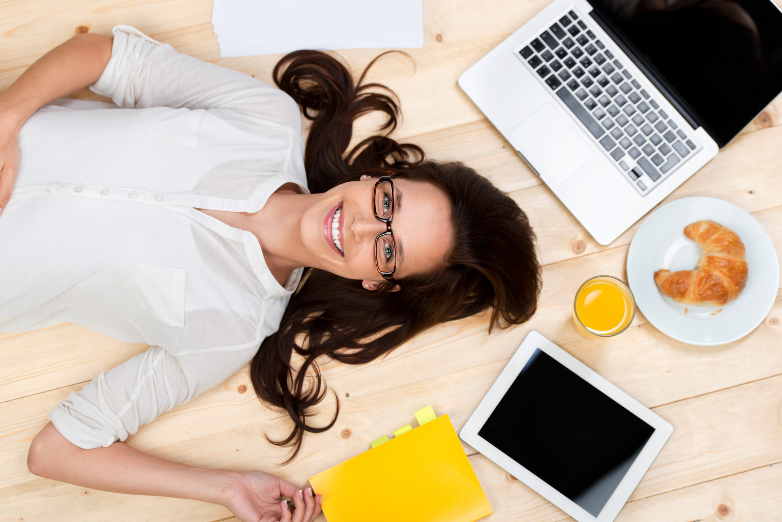 Smiling,Woman,Sitting,Thinking,In,An,Office,Chair,As,She